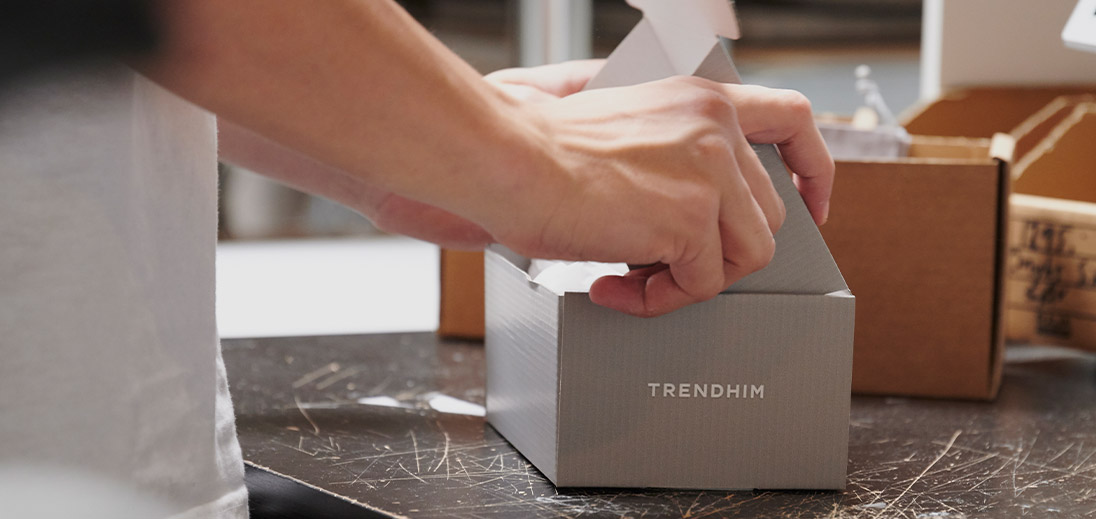 Man closing grey packaging