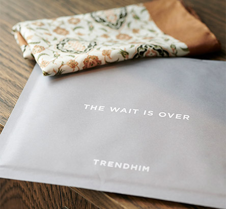 a grey branded packaging containing a scarf