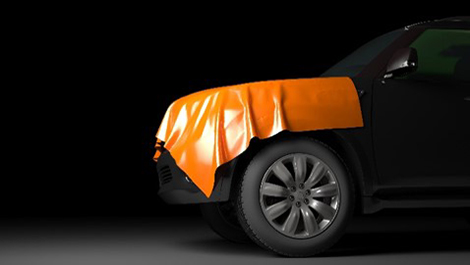 Film vinyle orange qui recouvre partiellement une voiture noire
